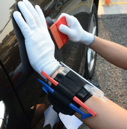 Magnetic Wrist Strap in action, securing vinyl wrapping tools for easy access during a project.
