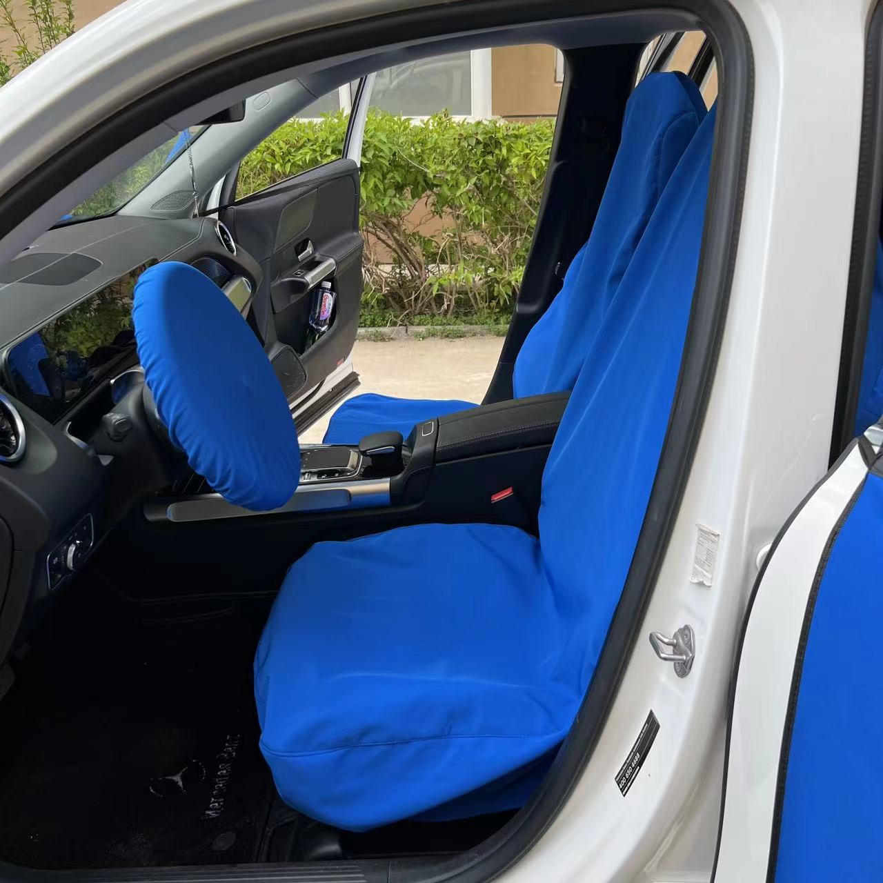 Protective Car Seat Cover securely fitted, demonstrating its effectiveness in preventing messes during vehicle maintenance tasks.
